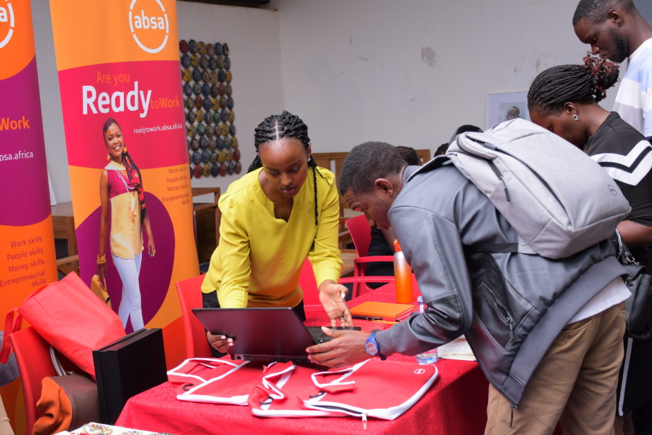 An Absa Bank Uganda staff member helps students sign up for the ReadytoWork programme during the 2022 NSSF Career Expo. The programme, provides training courses that cover essential work, entrepreneurial, money and work skills. This programme increases youth employability and supports job creation. To date there are 5,814 external beneficiaries from the ReadytoWork and Financial Literacy programme.