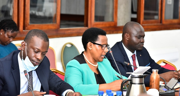 Hon Mugarra (left) and Ministry of Tourism Permanent Secretary, Doreen Katusiime (centre) before Parliament