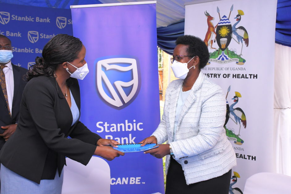 Stanbic Bank Chief Executive Anne Juuko (left) and Ministry of Health Permanent Secretary Dr Diana Atwine posing for a photo after signing a partnership to grant preferential banking and lending services to Uganda’s health care workers.