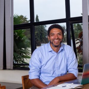 Peter Magona, Managing Director of TBWA\Uganda, in various settings including team meetings, award celebrations, and office portraits, reflecting his leadership in the advertising industry.