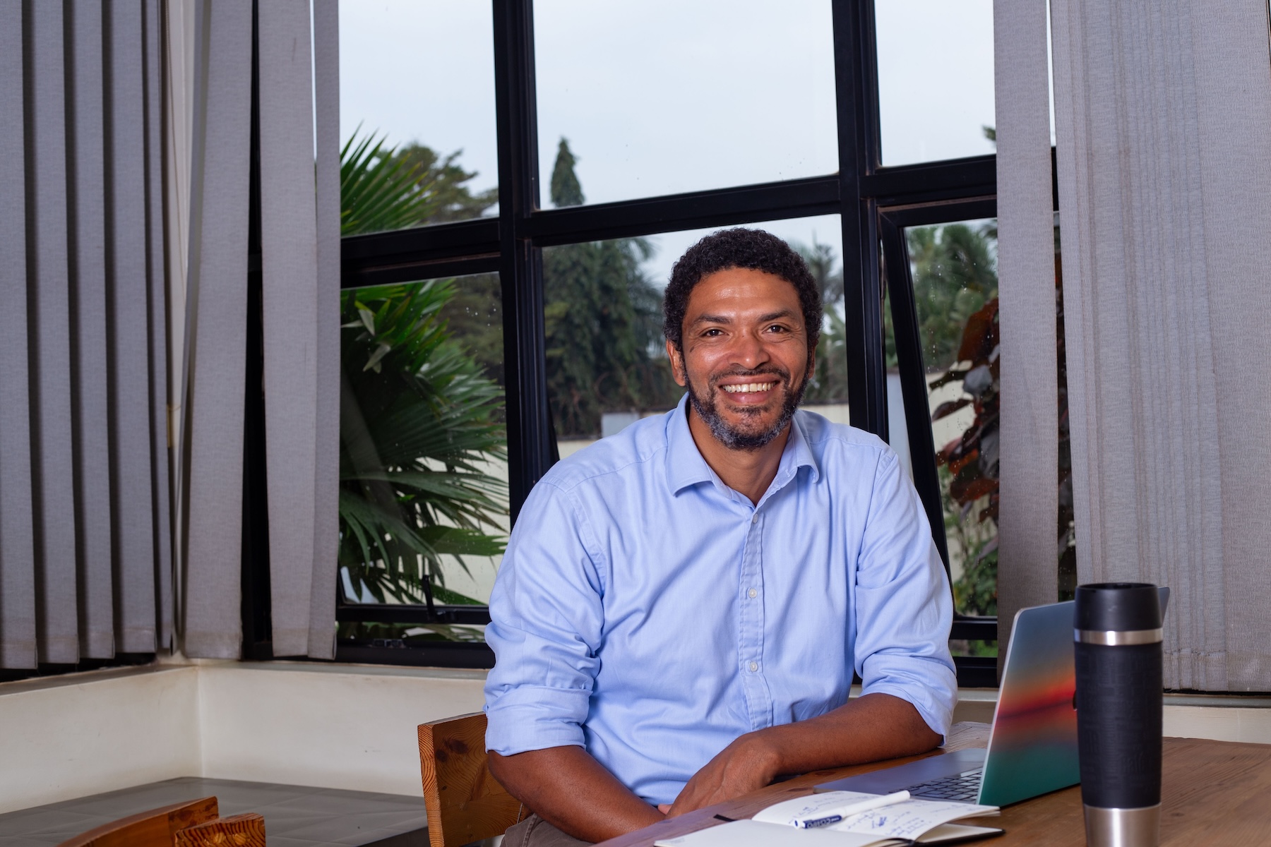 Peter Magona, Managing Director of TBWA\Uganda, in various settings including team meetings, award celebrations, and office portraits, reflecting his leadership in the advertising industry.