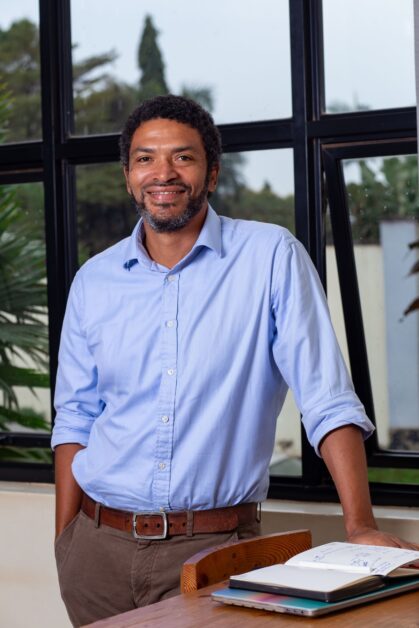 Peter Magona, Managing Director of TBWA\Uganda, in various settings including team meetings, award celebrations, and office portraits, reflecting his leadership in the advertising industry.