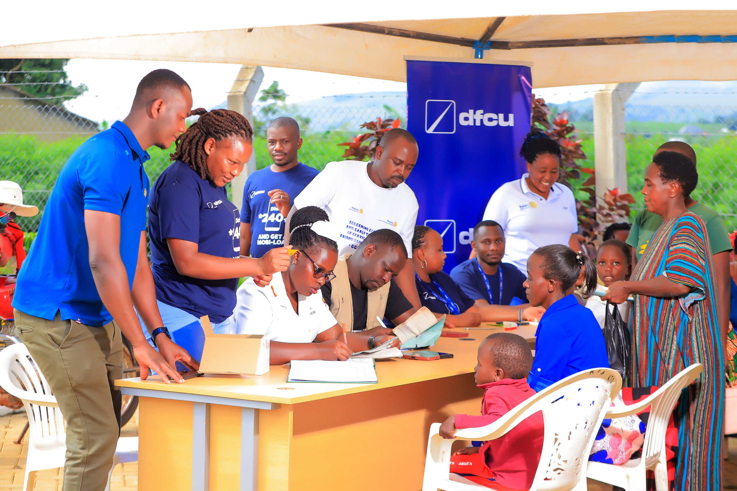 Medical officers examine patients during the recent dfcu Bank and Rotary Uganda medical health camps.