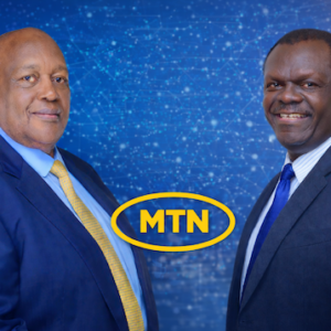 Charles Mbire (left) and NSSF Managing Director Patrick Ayota (right) pictured with the MTN Uganda logo as MTN shares rally and NSSF’s stake surpasses UGX 1 trillion.