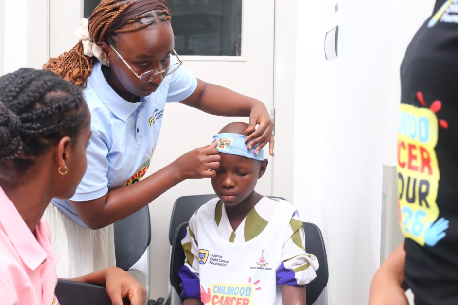 A young beneficiary is assisted with a Childhood Cancer Colour Run 2026 headband during the launch, symbolising the children at the heart of this year’s campaign and the stories behind every step.