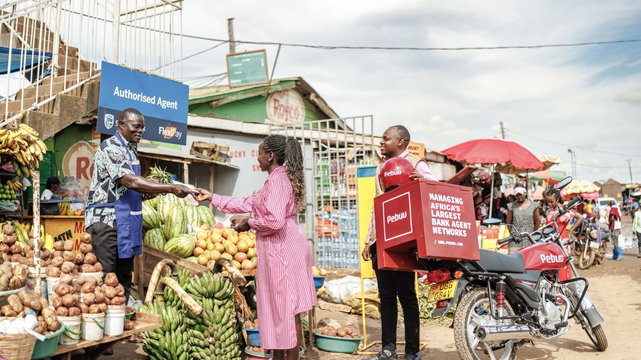 A Pebuu field supervisor supports an authorised bank agent at a local market, a scene that captures the quiet infrastructure behind Uganda’s agent banking boom. As trillions of shillings move through kiosks and trading centres each year, Pebuu’s on-the-ground teams ensure compliance, visibility, and operational discipline across Africa’s expanding last-mile financial networks.