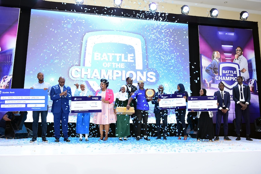 Minister of State for Gender, Labour, and Social Development in charge of Children and Youth Affairs, Balaam Barugahara, and Stanbic Bank Uganda Chief Executive Mumba Kalifungwa celebrate with students of Sumaya Girls School following their victory at the Stanbic National Schools Championship grand finale in September 2025, as winners receive prizes in a high-energy “Battle of the Champions” showcase—capturing the programme’s deeper purpose of nurturing entrepreneurial thinking early and building a pipeline of future innovators, business leaders, and job creators who will drive Uganda’s long-term economic growth.