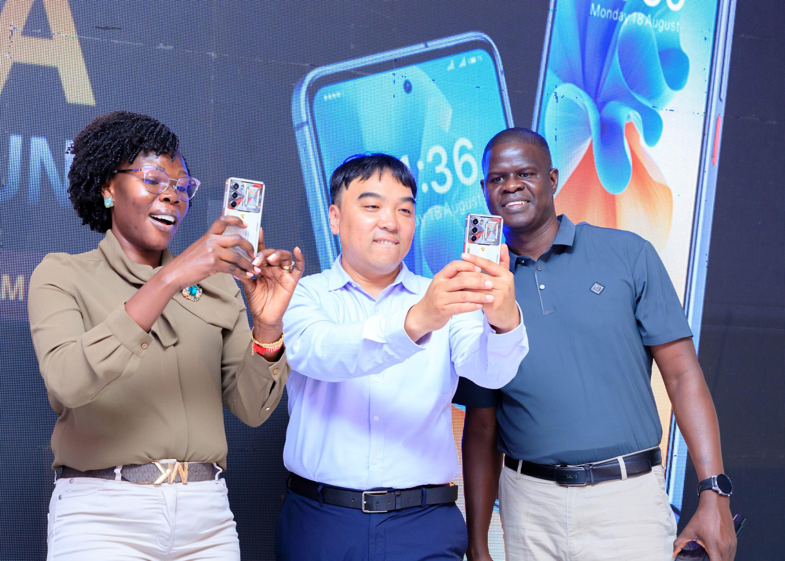 Investment Minister Evelyne Anite and other officials take selfies at the launch of a new SIMI Mobile phone series, reaffirming government support for local device assembly as part of Uganda’s industrialisation agenda. The initiative highlights efforts to boost domestic manufacturing, expand digital access, and position Uganda within regional technology value chains.