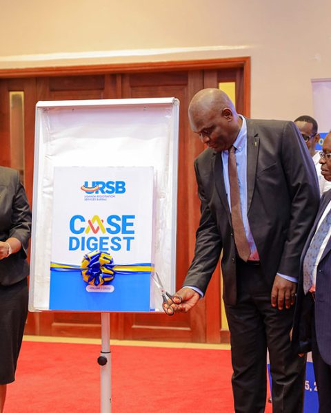 Hon Justice Mike Chibita, joined by URSB Board Chairman Amb. Can. Francis Butagira, PS Robert Kasande, and Registrar General Mercy K. Kainobwisho at the launch of the URSB Case Digest in Kololo, Kampala, highlighting how landmark rulings and successful litigation have helped save government billions of shillings while strengthening Uganda’s legal and business environment.