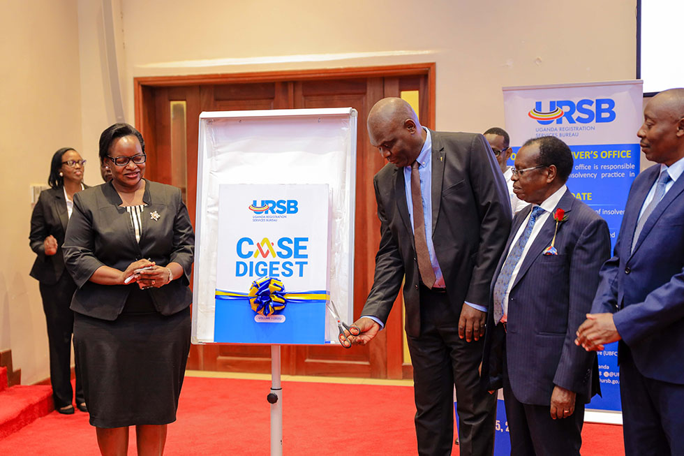 Hon Justice Mike Chibita, joined by URSB Board Chairman Amb. Can. Francis Butagira, PS Robert Kasande, and Registrar General Mercy K. Kainobwisho at the launch of the URSB Case Digest in Kololo, Kampala, highlighting how landmark rulings and successful litigation have helped save government billions of shillings while strengthening Uganda’s legal and business environment.