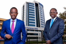 Godfrey Byekwaso (left), incoming Managing Director of Centenary Bank Uganda, with Fabian Kasi (right), the outgoing MD set to transition to Group CEO, against the backdrop of Mapeera House, the bank’s headquarters. This pivotal leadership shift at one of Uganda’s largest banks as it enters a new phase of growth and governance realignment.