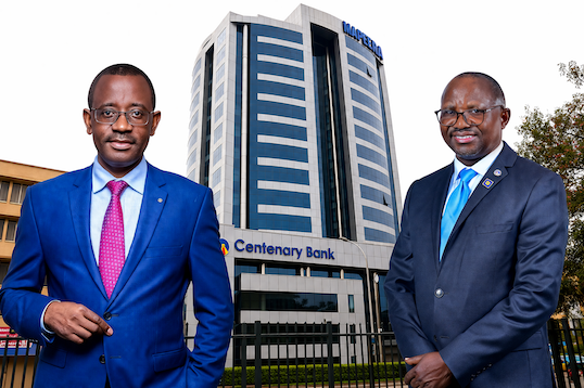 Godfrey Byekwaso (left), incoming Managing Director of Centenary Bank Uganda, with Fabian Kasi (right), the outgoing MD set to transition to Group CEO, against the backdrop of Mapeera House, the bank’s headquarters. This pivotal leadership shift at one of Uganda’s largest banks as it enters a new phase of growth and governance realignment.